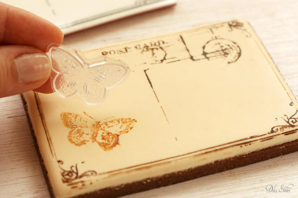 Stamping the iced cookie with butterfly stamp