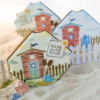 Distressed Beach Hut with Framed Message: Cookies and Photo by Julia M Usher; Stencils Designed by Julia M Usher with Confection Couture Stencils