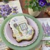 Same Deckled Cookie with Both Message and Crocus Appliqués: Cookie and Photo by Julia M Usher; Stencils Designed by Julia M Usher with Confection Couture Stencils