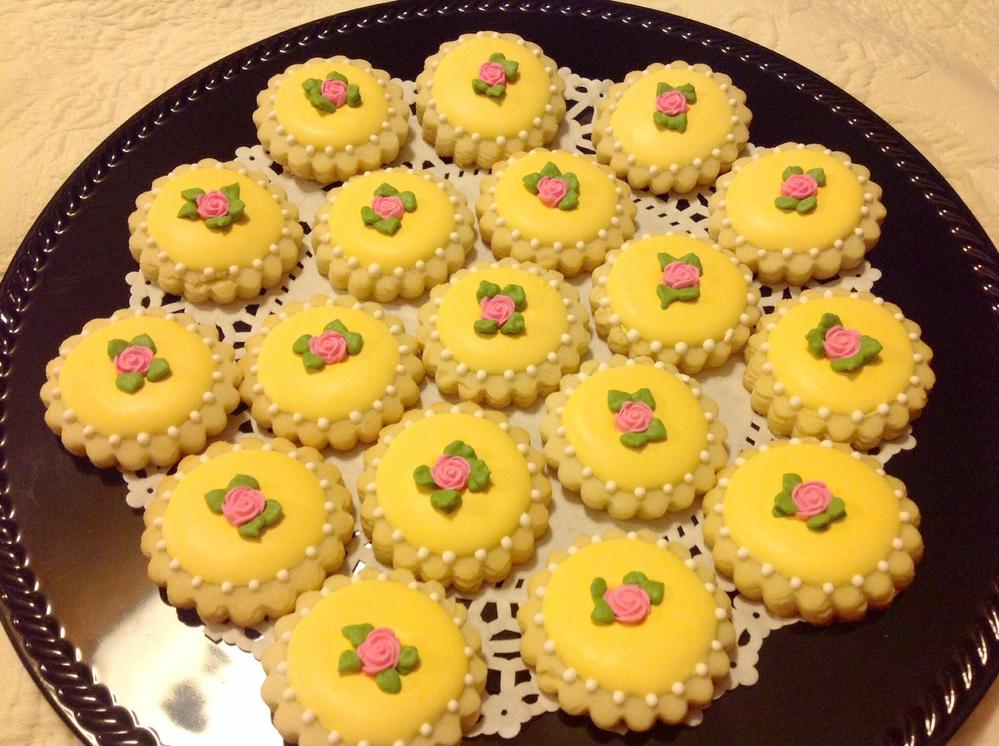 Yellow cookies with pink roses.